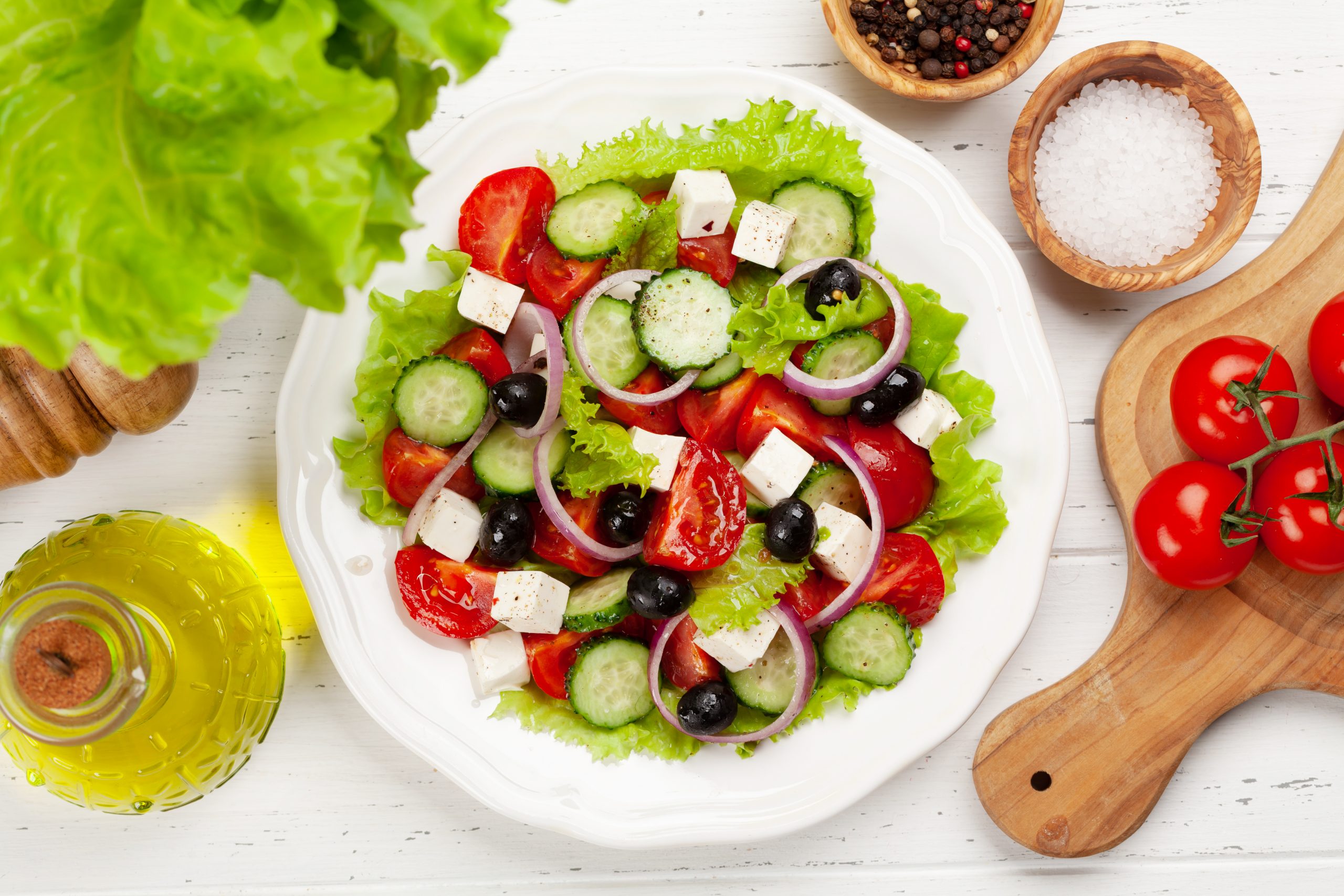 Classic greek salad with fresh garden vegetables. Top view flat lay