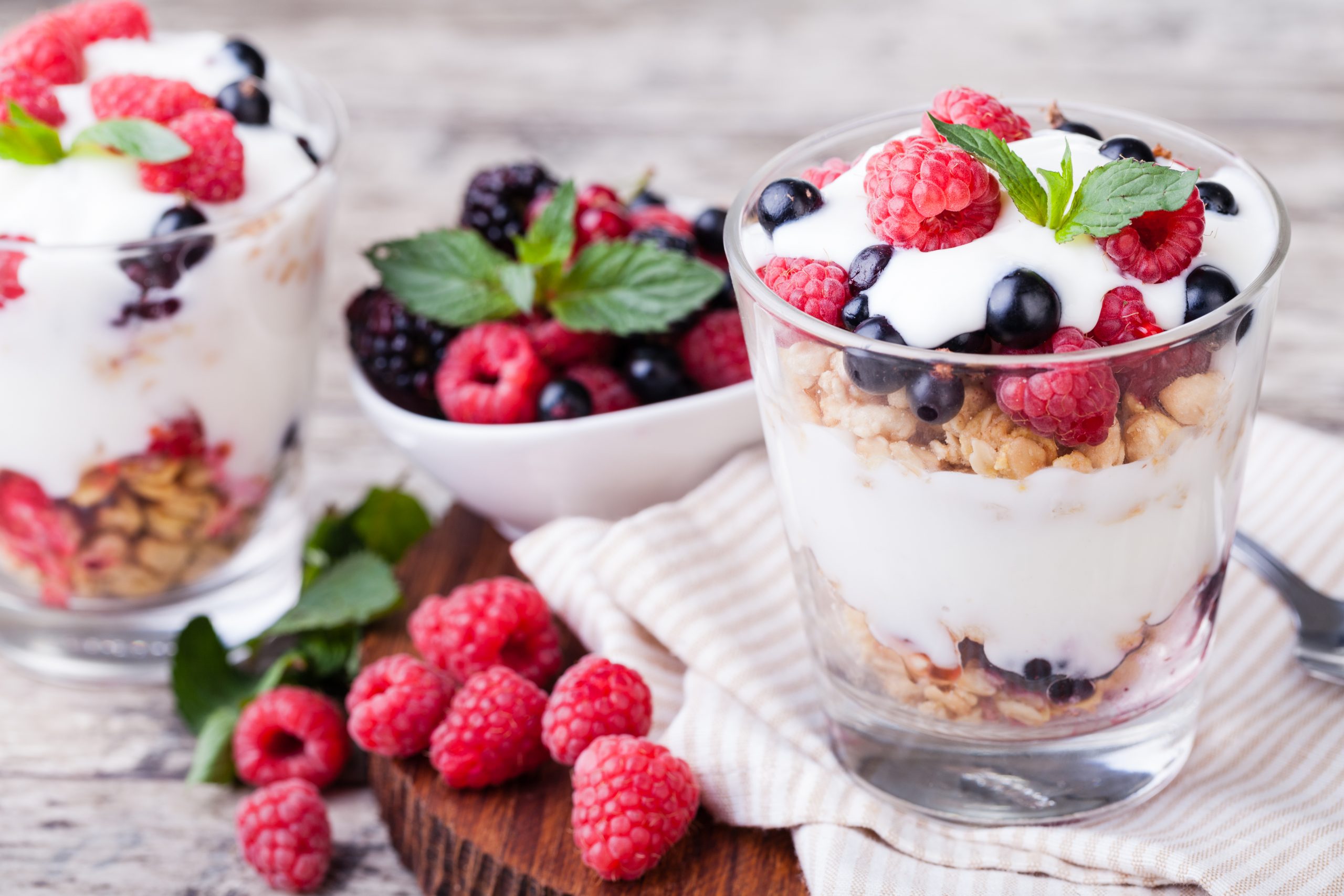 yogurt with muesli and berries on a wooden table